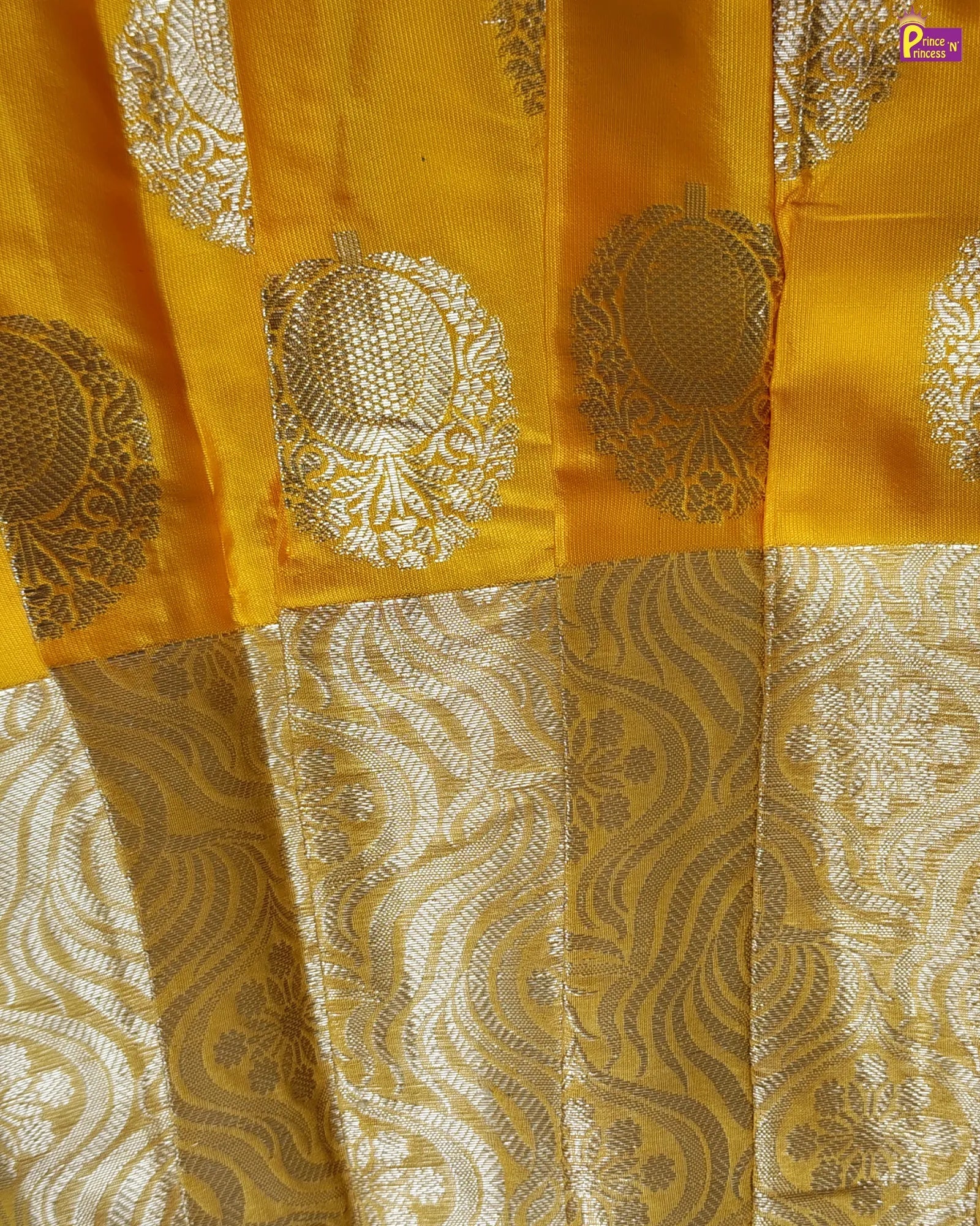 Yellow fabric with intricate gold patterns and embroidery