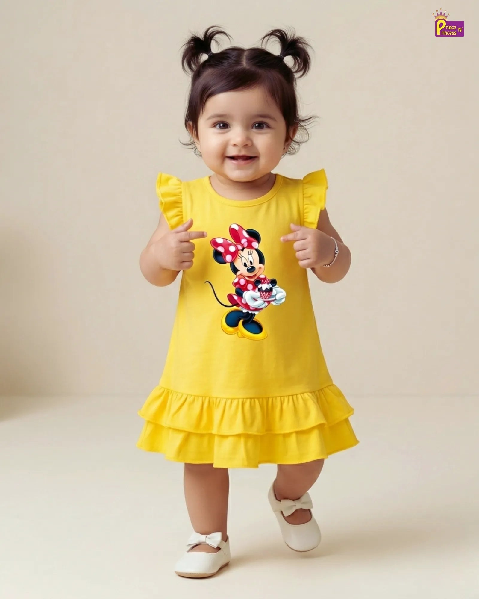 Child wearing a yellow dress with a Minnie Mouse design on a plain background