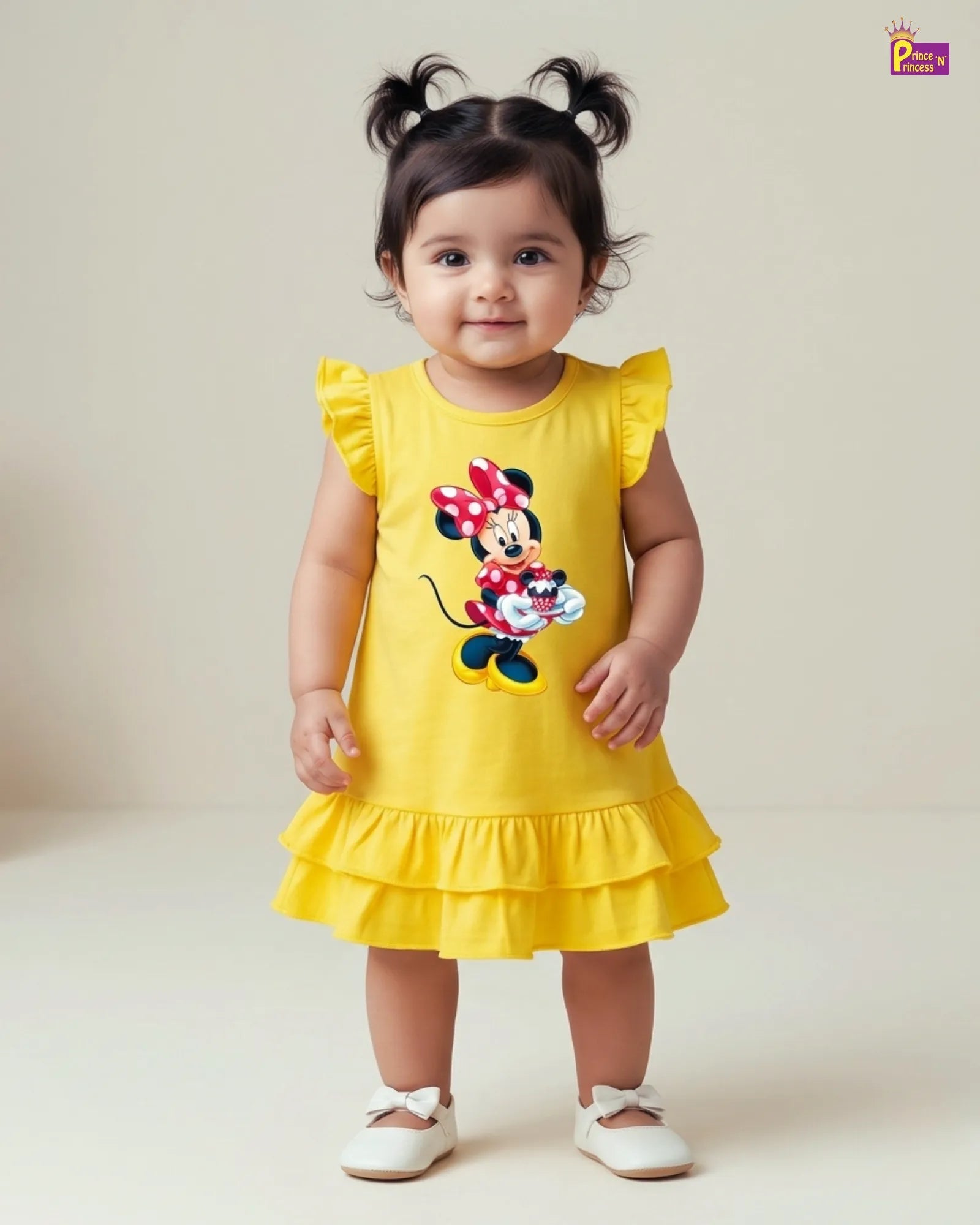 Child wearing a yellow dress with a Minnie Mouse design on a plain background